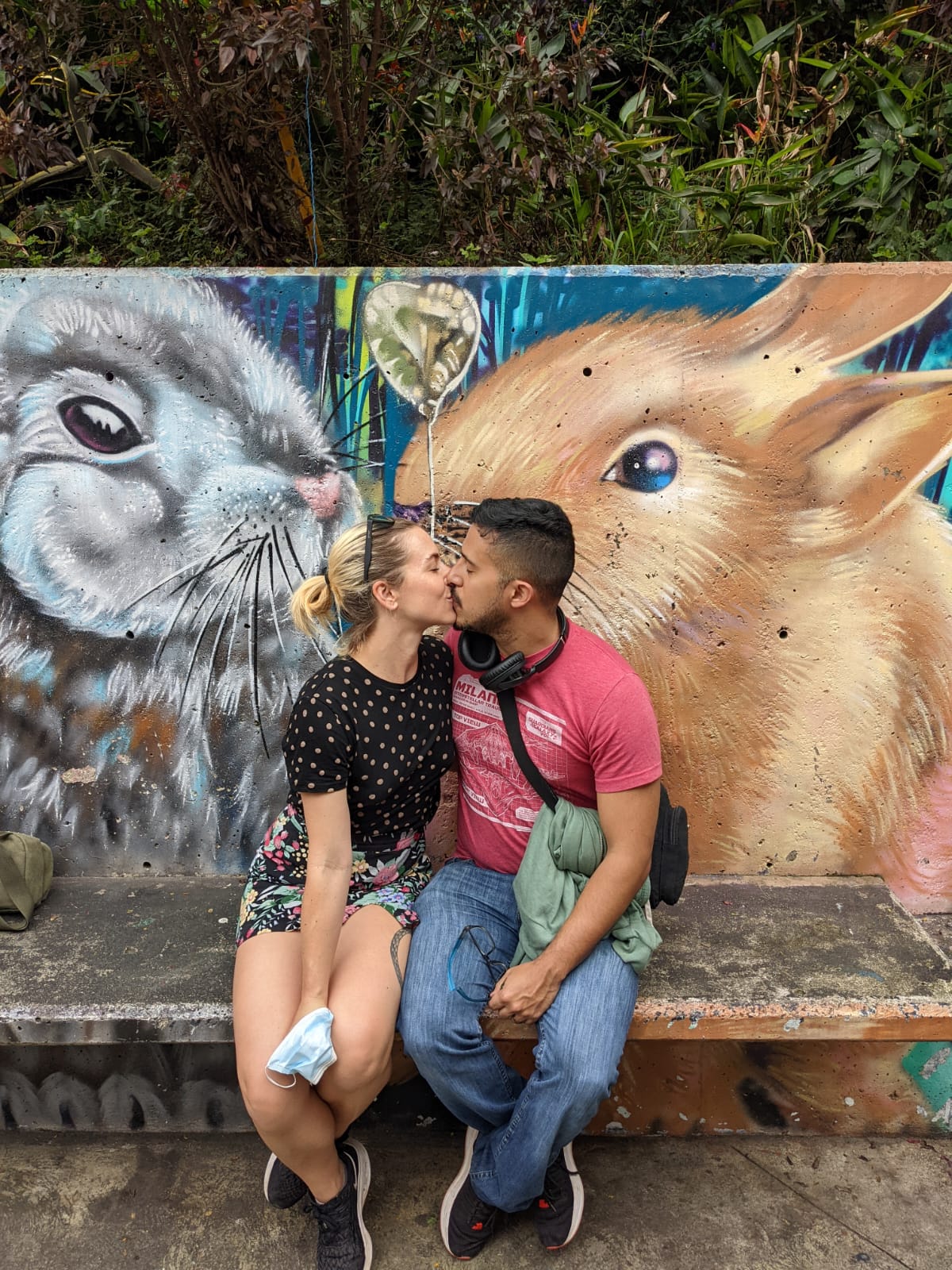 Author and husband in front of Comuna 13 mural